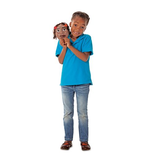 A photo of an African American girl in a blue shirt holding a completed self-portrait face mask that had been made with the Face-Shaped Crafting Molds.