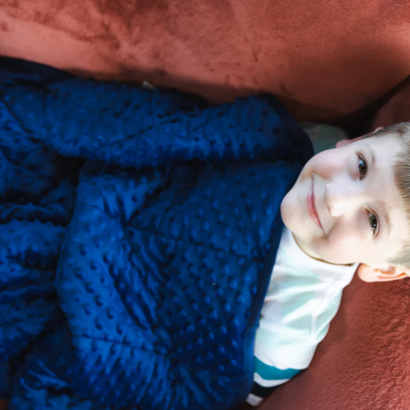 photo of a happy boy enjoying his 7lb sensory blanket