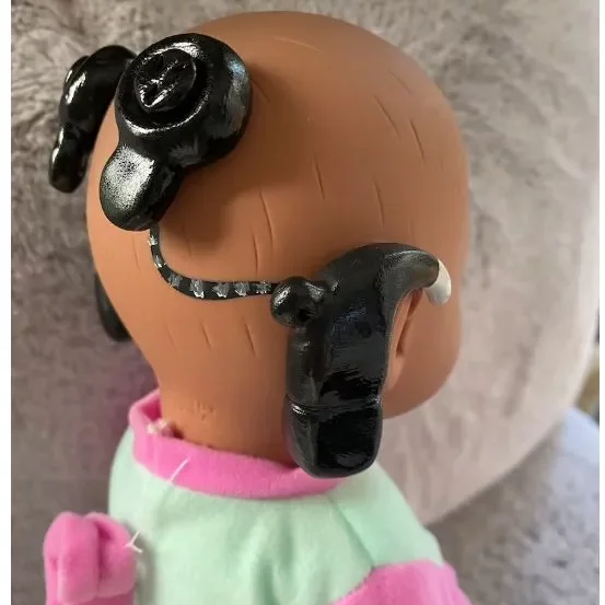 ethnic doll with cochlear implant